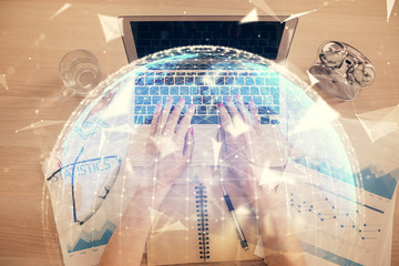 Double exposure of woman hands working on computer and financial theme hologram drawing. Top View. Business concept.