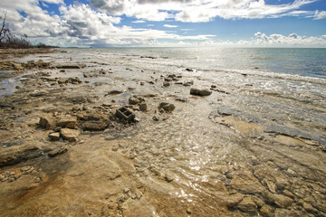 Rocky Shore Line on the Grand Bahama Island with a Cider Block on the Shore   