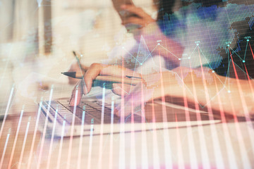 Multi exposure of woman hands typing on computer and financial graph hologram drawing. Stock market analysis concept.