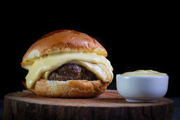 Craft beef burger with cheese and honey mustard sauce. .