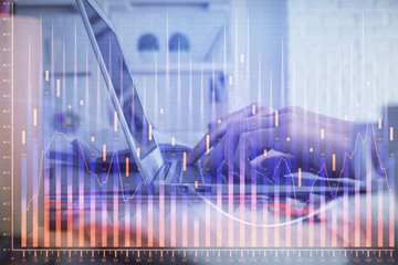 Double exposure of woman hands typing on computer and forex chart hologram drawing. Stock market...