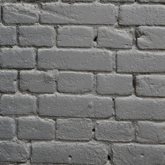 a piece of wall made of gray painted bricks