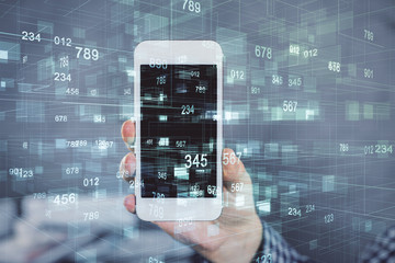 Double exposure of man's hand holding and using a digital device and data theme hologram drawing. Technology concept.
