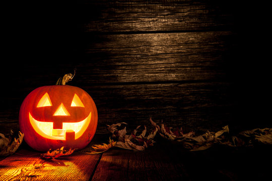 Halloween pumpkin head jack on wooden background