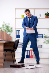 Young male employee businessman at workplace