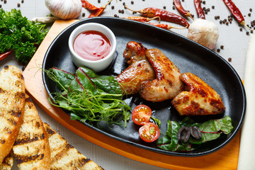 fried chicken wings served in a skillet