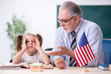 Old teacher and schoolgirl in the school