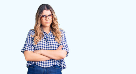 Young caucasian woman wearing casual clothes skeptic and nervous, disapproving expression on face with crossed arms. negative person.
