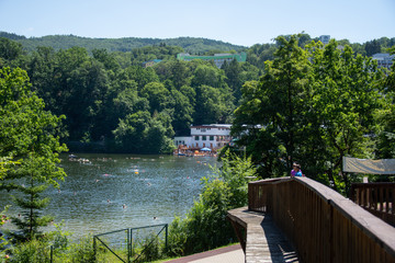 Fototapeta premium Romania 2020, People enjoying the sunshine on a hot summer day at the Bear Lake Thermal Spa in Sovata, Transylvania, 