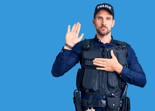 Young handsome man wearing police uniform swearing with hand on chest and open palm, making a loyalty promise oath