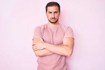 Young handsome man wearing casual tshirt skeptic and nervous, disapproving expression on face with...