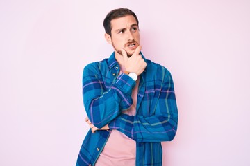 Young handsome man wearing casual clothes thinking worried about a question, concerned and nervous with hand on chin