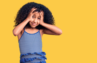 African american child with curly hair wearing swimwear suffering from headache desperate and stressed because pain and migraine. hands on head.