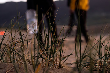 unrecognized men in the sand