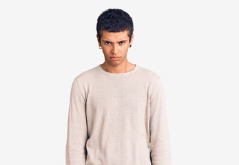 Young african amercian man wearing casual clothes skeptic and nervous, frowning upset because of...