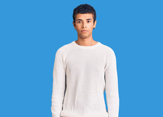 Young african amercian man wearing casual clothes relaxed with serious expression on face. simple and natural looking at the camera.