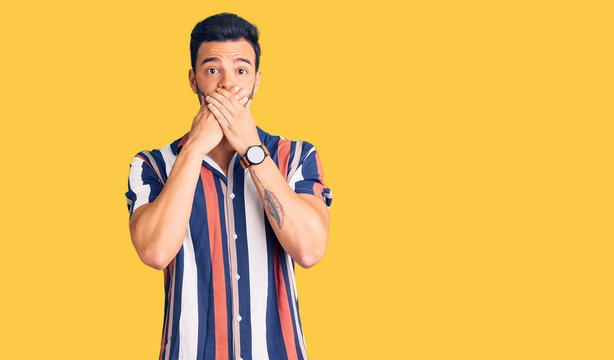 Young handsome hispanic man wearing casual  summer shirt shocked covering mouth with hands for mistake. secret concept.