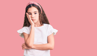 Cute hispanic child girl wearing casual white tshirt thinking looking tired and bored with depression problems with crossed arms.