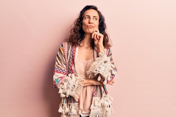 Young beautiful hispanic woman wearing casual clothes serious face thinking about question with hand on chin, thoughtful about confusing idea