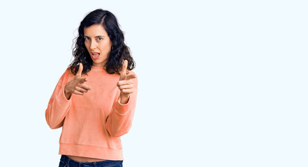 Young beautiful hispanic woman wearing casual clothes pointing fingers to camera with happy and funny face. good energy and vibes.