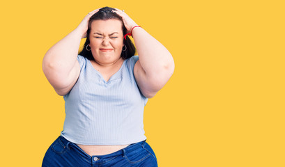 Young plus size woman wearing casual clothes suffering from headache desperate and stressed because pain and migraine. hands on head.
