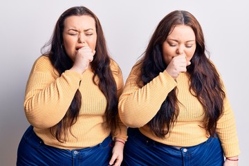 Young plus size twins wearing casual clothes feeling unwell and coughing as symptom for cold or bronchitis. health care concept.