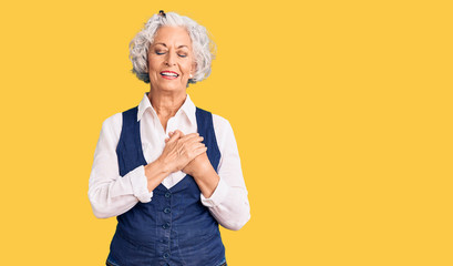 Senior grey-haired woman wearing casual clothes smiling with hands on chest with closed eyes and grateful gesture on face. health concept.