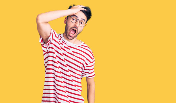 Young hispanic man wearing casual clothes surprised with hand on head for mistake, remember error. forgot, bad memory concept.