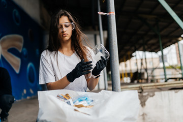 Young woman sorting garbage. Concept of recycling. Zero waste