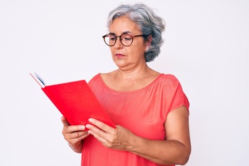 Senior hispanic woman wearing glasses holding book thinking attitude and sober expression looking self confident