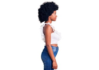 Young african american woman wearing casual clothes looking to side, relax profile pose with natural face with confident smile.