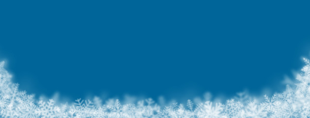 Christmas background of snowflakes of different shapes, sizes, blur and transparency on blue background