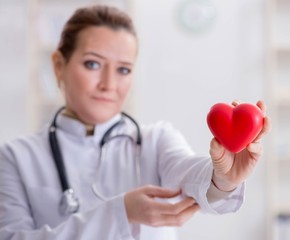 Cardiologist with red heart in medical concept