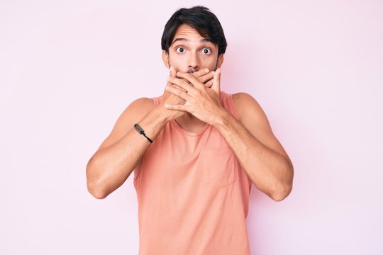 Handsome hispanic man wearing casual clothes shocked covering mouth with hands for mistake. secret concept.