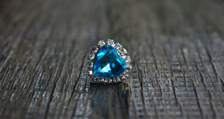 
White gold necklace pendant
Heart shaped aquamarine rests on the wooden floor.