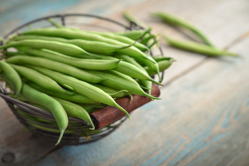 Raw green beans in metal basket