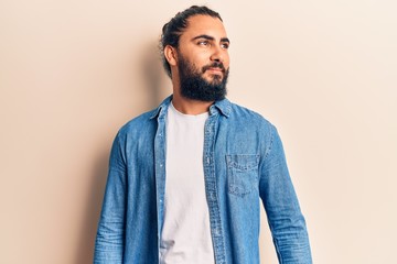Young arab man wearing casual clothes looking to side, relax profile pose with natural face and confident smile.