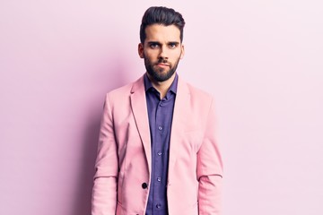 Young handsome man with beard wearing elegant jacket skeptic and nervous, frowning upset because of problem. negative person.