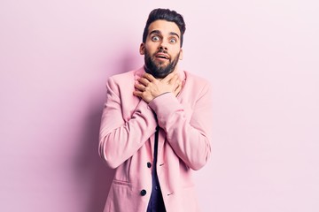 Young handsome man with beard wearing elegant jacket shouting and suffocate because painful strangle. health problem. asphyxiate and suicide concept.