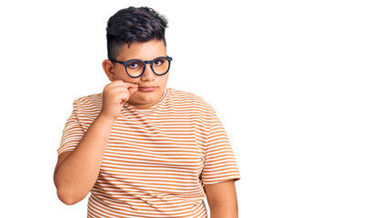 Little boy kid wearing casual clothes and glasses mouth and lips shut as zip with fingers. secret...