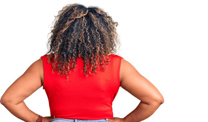 Young african american plus size woman wearing casual style with sleeveless shirt standing...