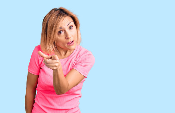 Young blonde woman wearing sportswear pointing displeased and frustrated to the camera, angry and furious with you