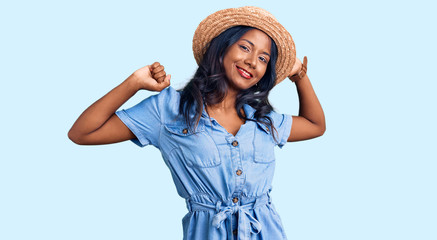 Young indian girl wearing summer hat stretching back, tired and relaxed, sleepy and yawning for early morning