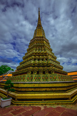 Fototapeta premium background of important religious attractions in Bangkok (Wat Phra Chetuphon (Wat Pho - reclining Buddha), a large pagoda and beautiful sculptural art give future generations to explore its history
