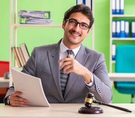 Young handsome lawyer working in the office