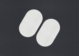 Blank white Business card mockup stacks on grey textured paper background.