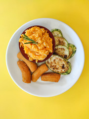 vegan meal fried bananas pumpkin risotto and zucchini 