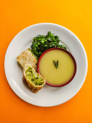 Fototapeta na wymiar vegetable soup green leafs and broccoli strudel