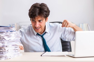 Overloaded busy employee with too much work and paperwork