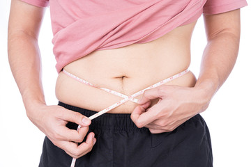 Chubby man measuring his waist with white measuring tape isolated on white background. Diet lifestyle, weight loss, stomach muscle, healthy concept.